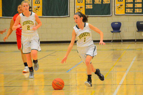 SENIORS ATTACK. Carly Swartz brings the ball upcourt for the Hornets, with classmate Tristan Hoffman on her right. (John Friberg Photo)