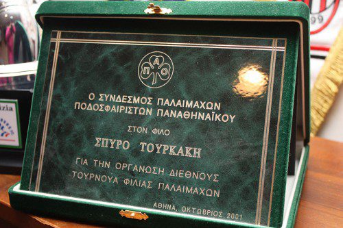 THIS PLAQUE from his native Athens commemorates the first international tournament game in which the Boston Braves competed in October 2001. It is proudly displayed in the trophy room of Spiros Tourkakis's Lynnfield home.(Maureen Doherty Photo)