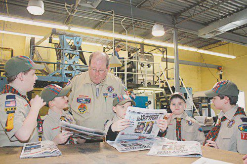 WEBELOS from Pack 722, Den 3 dropped by the pressroom of the Wakefield Daily Item to learn about the news gathering process as they work toward their Communications badge. The scouts examined the first copies of Wednesday's edition as it came off the web press with Den leader Tom Markham. (Maureen Doherty Photo)