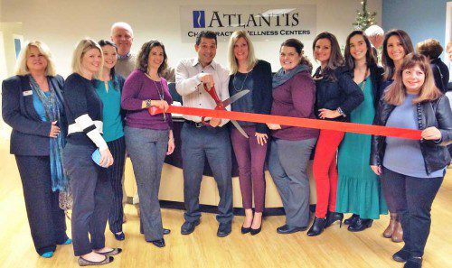 THE WAKEFIELD LYNNFIELD Chamber of Commerce recently held a ribbon cutting at the grand re-opening of Atlantis Chiropractic Wellness Centers at 1 Teal Rd. in Wakefield. The center recently moved back into its office after being displaced by three separate floods. Among those who attended the ribbon cutting were (left to right) Theresa Carson, Wakefield Co-operative Bank; Lori Konstatny, Atlantis Wellness; Chamber Director Sarah McDonald, Edward Jones Investments; Chamber 2nd Vice President Bob Sardella, Sardella Signs; Chamber Executive Director Marianne Cohen; and Dr. Peter Martone, Kelly Martone, Brandy Rodriquez, Anna Laste, Laurel Byrne, Jen Quadrozzi, all of Atlantis Wellness; and Chamber co-President Cheryl Carroll, Mary Kay Independent Consultant. 