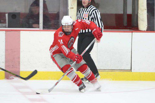 JAKE REGAN, a freshman defenseman, stickhandles the puck for the Warriors. The Wakefield defense played pretty well but Wakefield was blanked by fifth-ranked Winchester last night at the O’Brien Rink. (Donna Larsson File Photo)