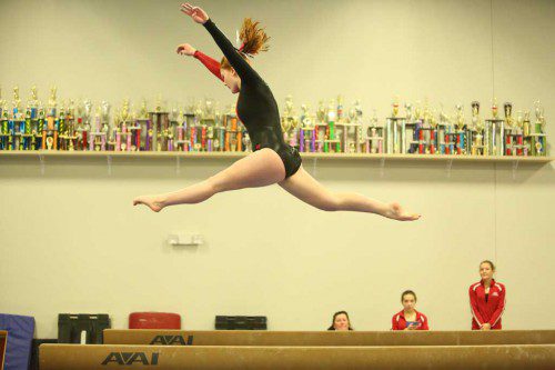 CASEY KEARNEY, a freshman, performs on the balance beam during Wakefield’s meet against Melrose. Kearney scored a 7.4 on beam. However Kearney’s best event on Tuesday night was the floor exercise where she finished second with a score of 8.5. (Donna Larsson Photo)