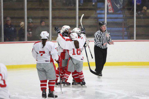 MEMBERS OF the Warrior girls’ hockey team celebrate. Wakefield had plenty of reason to be happy on Saturday as it posted a 9-2  victory over Belmont at the Kasabuski Arena. (Donna Larsson File Photo)
