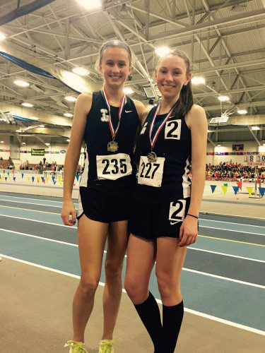 THE PIONEER duo of Liz Reed (left) and Kate Mitchell scored points for the LHS girls' indoor track team at the CAL Championships Feb 2. Reed took fourth in the 300m (44.11) while Mitchell won the 600m CAL title (1:40.87) and anchored the championship 4x800m team. (Courtesy Photo)