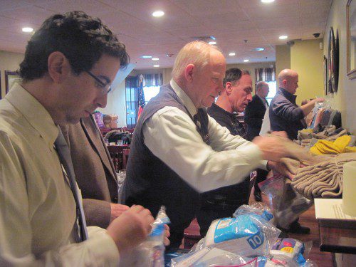 WAKEFIELD Rotarians Tom Stapleton and Jim Fitzgerald helped assemble “warm kits” at yesterday’s lunch meeting that were distributed to 100 homeless women and their children at Rosie’s Place in Boston. (Gail Lowe Photo)