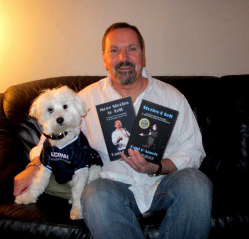 WAKEFIELD NATIVE and comedian Paul D’Angelo is shown with his books and a favorite companion Duffy, part Wheaton terrier and part poodle.