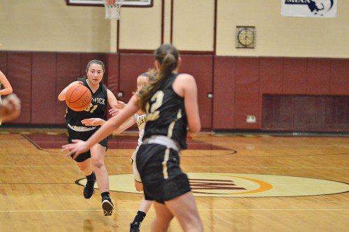 BISHOP FENWICK’S SYDNEY BRENNAN, (left), brings the ball upcourt against the North Reading defense in the March 12 game played at Whittier Tech. (Bob Turosz Photo)