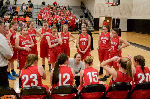 HEAD COACH Meghan O’Connell (center) talks to her team during last night’s state tournament game against Arlington Catholic. The Warriors dropped a 57-51 game to the Cougars in overtime to have their season come to an end. (Donna Larsson Photo)