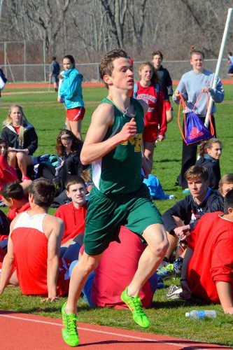 SENIOR BRENDAN CARTER, who recently signed a letter of intent to run for Assumption College next year, wins the mile run. (John Friberg Photo)