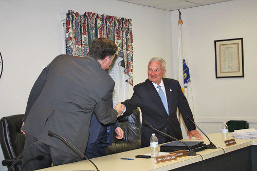 WELCOME aboard. Newly elected Selectman Dick Dalton (right) is congratulated by Selectman Chris Barrett following his election to his first term Monday night over challenger Michael Walsh. (Maureen Doherty Photo)
