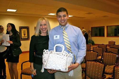 STUDENT entrepreneur Juan Camilo Hernandez (right) was awarded $800 in start-up capital to help launch Camilo, his own line of high-end designer handbags. A student in the Young Entrepreneurs Academy (YEA!) sponsored by the Peabody Area Chamber of Commerce, he is pictured with Kathy Boudreau of Circle Insurance, an instructor and mentor of the YEA. (Courtesy Photo)