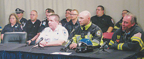 Seated at the table are (from left) Michael Woronka, Chief Executive Officer of Action Ambulance Services, Inc.; Wakefield Police Officer David Rando; and Lt. Louis Sardella of the Wakefield Fire Department. Seated behind them are other local police officers, firefighters, as well as EMTs and paramedics from Action Ambulance. (Mark Sardella Photo)