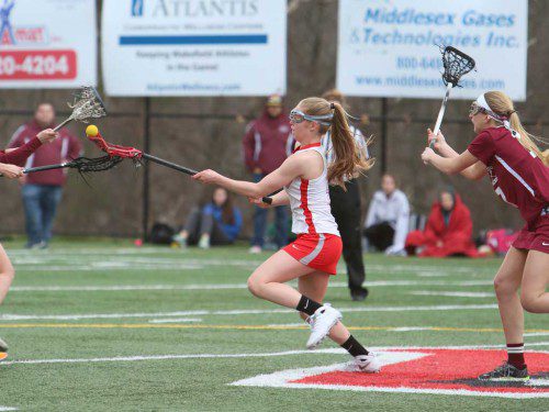 KELSEY CZARNOTA, a junior (middle), was a dominant force in the middle for the Warriors on Friday afternoon at Landrigan Field. Czarnota tallied six goals and assisted on four others as Wakefield won its season opener by a 15-3 score over Gloucester. (Donna Larsson Photo)
