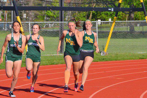 SENIOR Alexa Capozzoli (right) hands the baton off to her classmate Julia Valenti in the 4 x 100 meter relay. In an exciting finish, Valenti caught her Pentucket opponent at the wire to propel North Reading to a victory. (Courtesy Photo)