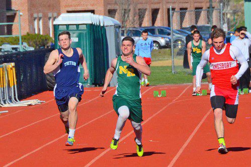NORTH READING SENIOR Angelo DiSanto is neck and neck in the 100 meter dash with his Triton and Amesbury opponents. (John Friberg Photo)