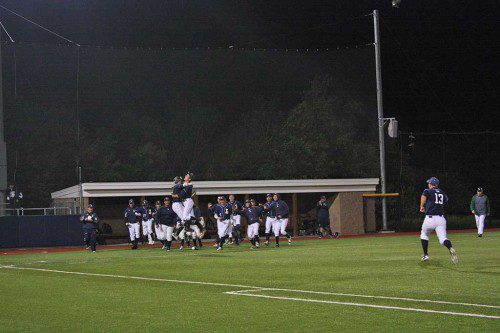 JUMPING for joy. Catcher Dan O'Leary and pitcher Nick Colucci jump for joy as their teammates storm the field following their 8-7 comeback win over Austin Prep in the Div. 3 North semifinal game played Thursday night. The Cougars had eliminated the Pioneers from last year's tourney. (Maureen Doherty Photo)