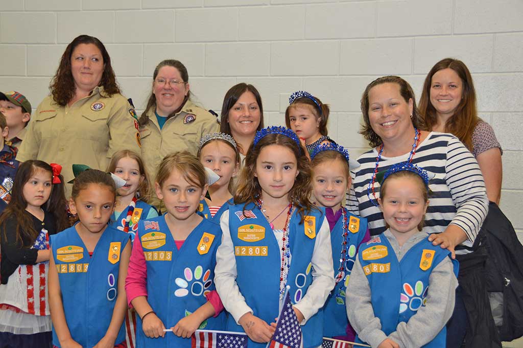 NORTH READING GIRL SCOUTS helped swell the crowd at Memorial Day ceremonies, held indoors at the Batchelder School gymnasium on Monday. The indoor ceremonies unfolded before a large audience. (Bob Turosz Photo)