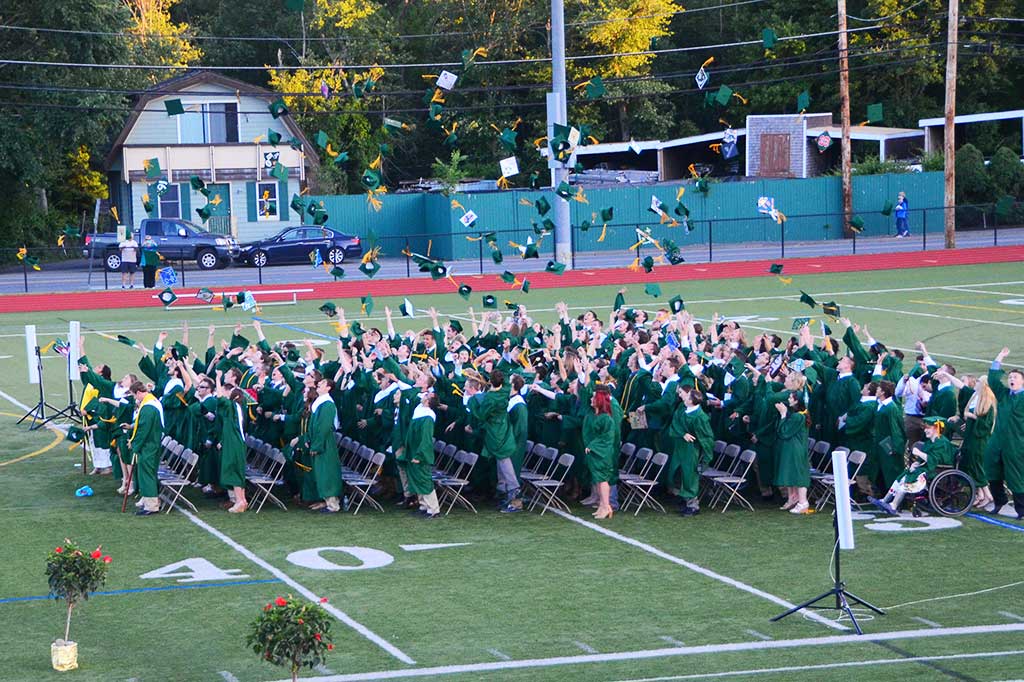 THEIR LAST ACT AS A CLASS. Members of the NRHS Class of 2015 toss their mortarboards into the air. They are now graduates and young adults. (John Friberg Photo)