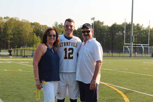 BOYS’ LACROSSE captain Trevor Caswell is flanked by his parents Lisa and Ted during the Pioneers’ Senior Day ceremony held before Lynnfield defeated North Reading 5-2 May 25. (Kerrianne Allain Photo)