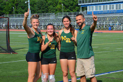 NORTH READING has the best pole vault team in the state! From left: Julia Valenti, Rachel Hill, Victoria Grasso, and Coach Sotirios Pintzopoulos. Valenti finished first with a mark of 12 feet 4 inches and Hill was runner up at 10 feet 4 inches. (John Friberg Photo)