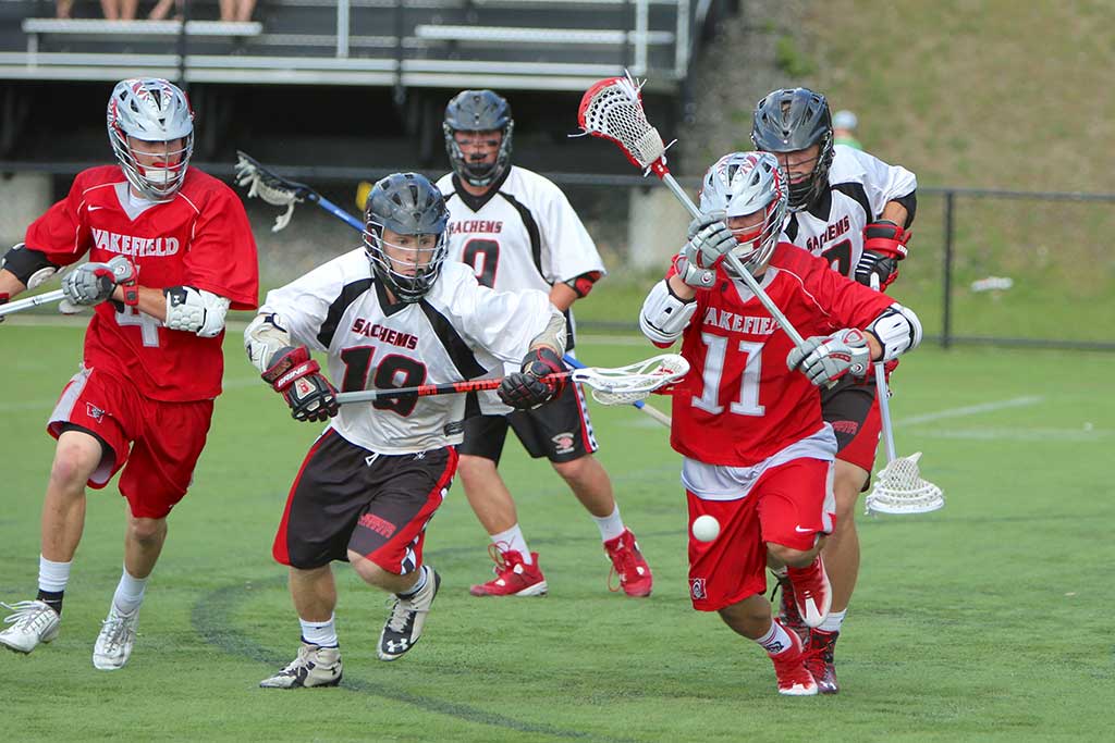 WARRIOR players Austin Collard (#4) and Brandon Grinnell (#11) provided Wakefield with plenty of offense with four and three goals, respectively, in the boys’ lacrosse team’s Div. 2 North semifinal game against Winchester last night at Knowlton Stadium. (Donna Larsson Photo)