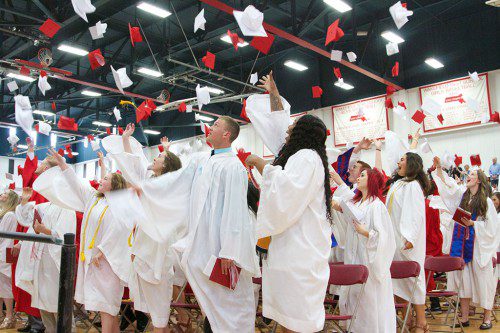 WITH THEIR HIGH SCHOOL careers officially behind them, members of the Wakefield Memorial High School’s Class of 2016 do a little celebrating during Saturday’s commencement exercise. More photos appear throughout today’s edition of the Daily Item. (Donna Larsson Photo)