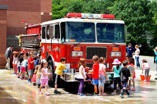 ON THURSDAY, June 9, Dolbeare School kindergarteners had a chance to scrub Engine 4 clean. Everyone had a great time doing it. (Jay Tracy Photo)