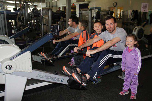 PATRICK CURLEY trained for the 2016 C.R.A.S.H.-B. Sprints World Indoor Rowing Championships on an “erg” at the Peabody/Lynnfield Torigian Family YMCA to raise funds for Multiple Sclerosis research. Among his biggest fans were his son Alan and daughter Hannah. (Courtesy Photo)