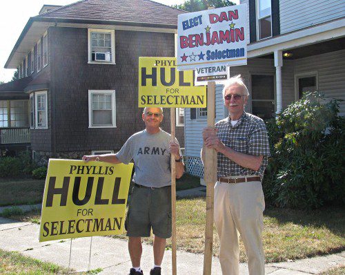 HOLDING SIGNS at the corner of Gould Street and Harrington Court this morning were Bob McCorry (left) and Bill Chetwynd. Precincts 5 and 6 are voting at the West Side Social Club on Harrington Court in today’s Special Election for a seat on the Board of Selectmen. Six candidates are in the running for the job. The polls are open until 8 p.m. (Mark Sardella Photo)