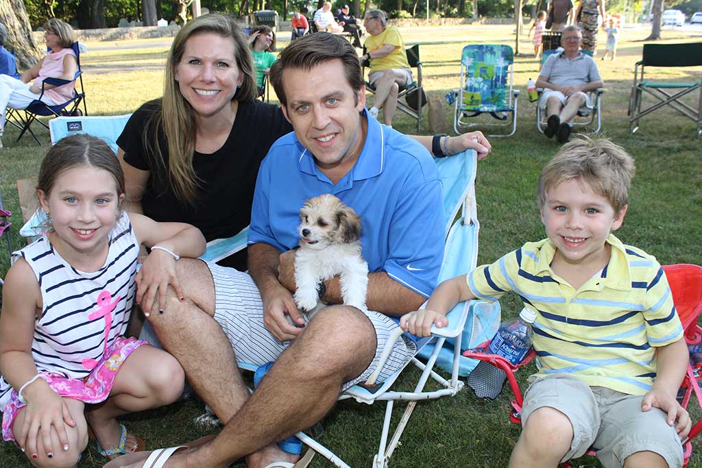 TEN-WEEK-OLD Charlie the puppy knows how to be the center of attention in the Mitchell family. He enjoyed his outing to Rotary’s summer concert on the common last week with Julie and Paul Mitchell and their children, Sarah, 7, and William, 5. (Maureen Doherty Photo)