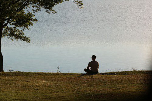THIS MAN IS completely relaxed as he uses Lake Quannapowitt as a place to reflect. (Donna Larsson Photo)