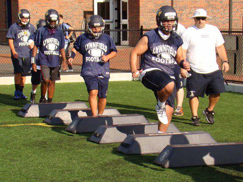 ASSISTANT coach Gino Fodera works a group of Pioneers through an agility drill in the first non-contact conditioning practice of the season held last Friday. (Tom Condardo Photo)