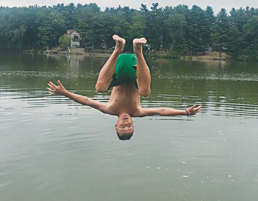 JOEY CUCCINIELLO, 10, performs an acrobatic somersault into Pillings Pond to get relief from the summer heat and humidity. He lives on Beechwood Road in the Pillings Pond neighborhood. (Courtesy Photo)