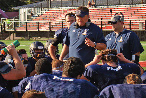 HEAD COACH Neal Weidman reviews strategies with his team at halftime during Friday's Melrose scrimmage. (Tom Condardo Photo)