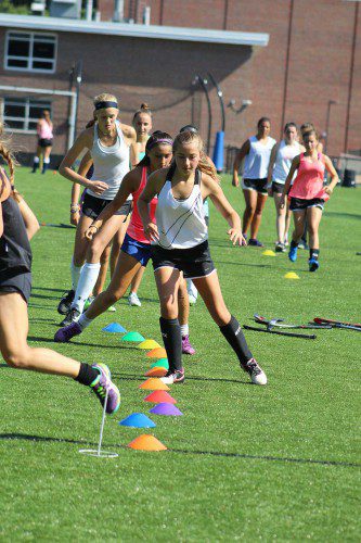 ZIG-ZAGGING through a set of cones during drills at practice are field hockey players (from to back): Jenna Kelly, captain Lilli Patterson, Carolyn Garofoli and Mia Lemieux. The Pioneers won their season opener with a 2-0 shutout over Triton. (Maureen Doherty Photo)