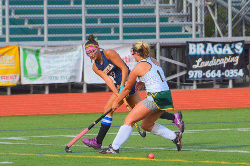 SENIOR captain Lilli Patterson (dark jersey) passes the ball through the legs of an advancing North Reading opponent. Patterson scored two goals in the 6-0 shutout and followed up with two goals the next day in a 7-0 shutout over Rockport. (John Friberg Photo)