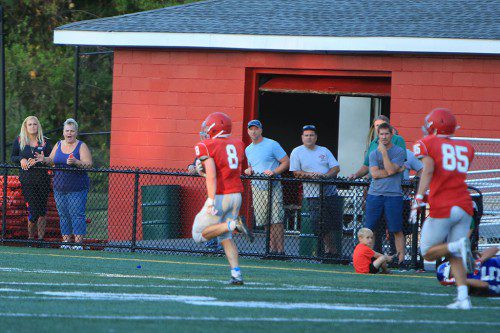 JOE MARINACCIO scored a touchdown on a 70 yard run on a read option play while lining up at quarterback for the play in the Warrior football team’s scrimmage against Methuen on Tuesday night at Landrigan Field. (Donna Larsson Photo)