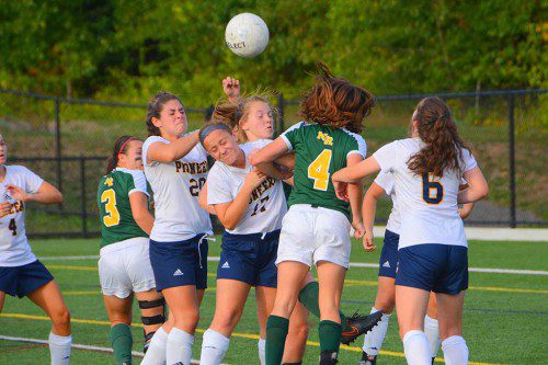 CAPTAIN Sydney Santosuosso (17) completes a header while in traffic during the Pioneers’ 1-0 victory over North Reading Sept. 21. (John Friberg Photo)