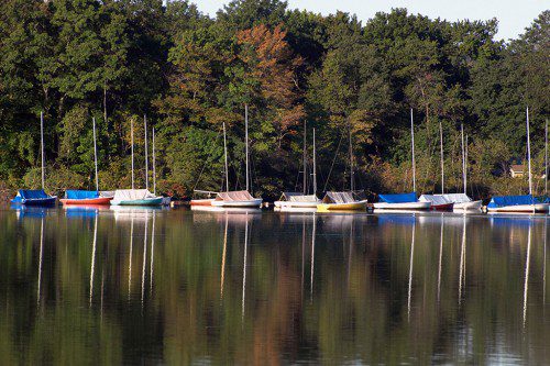 LAST THURSDAY, on the cusp of autumn, the fall colors around Lake Quannapowitt and the sailboats of the yacht club cast reflections on the water’s surface. (Robert Pushkar Photo) 