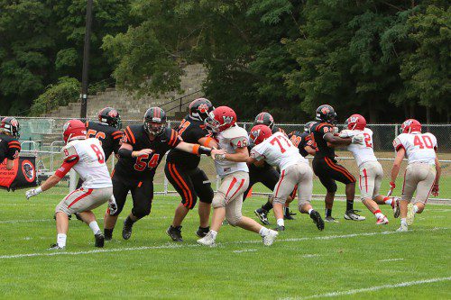 THE WARRIOR defense engages the Beverly offensive line during Saturday’s game at Hurd Stadium. The Warriors (from left to right) are Joe Marinaccio (#8), Alex Joly (#45), Devin O’Brien (#77), Carmen Sorrentino (#2), and PJ Iannuzzi (#40). (Donna Larsson Photo)