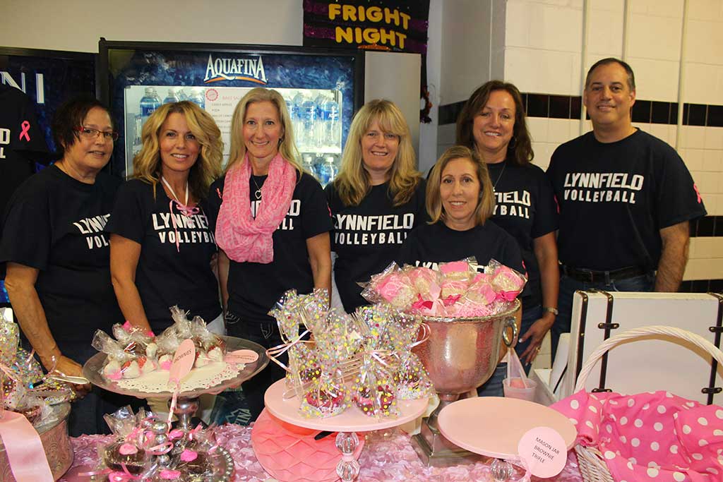 THE VOLLEYBALL TEAM held its annual Dig Pink breast cancer research fundraiser during the Lynnfield vs. Masconomet match Oct. 5, which the Pioneers won 3-0. Dedicated parents, from left, Susan Nugent, Susan Pascucci, Leslie Kerzmer, Keri Pagliuca, Jen Albanese, Lisa Caswell and Steve Kotler ran the bake sale table during the event. The fundraiser’s proceeds were donated to the Side-Out Foundation. (Dan Tomasello Photo) 