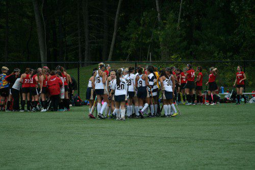 THE FIELD HOCKEY team regroups during a timeout against Amesbury. All 21 varsity players contributed to Lynnfield's 4-0 win over the Indians in the team's eighth shutout of the year last Friday to maintain first place in the CAL large division. (Maria Terris Photo)