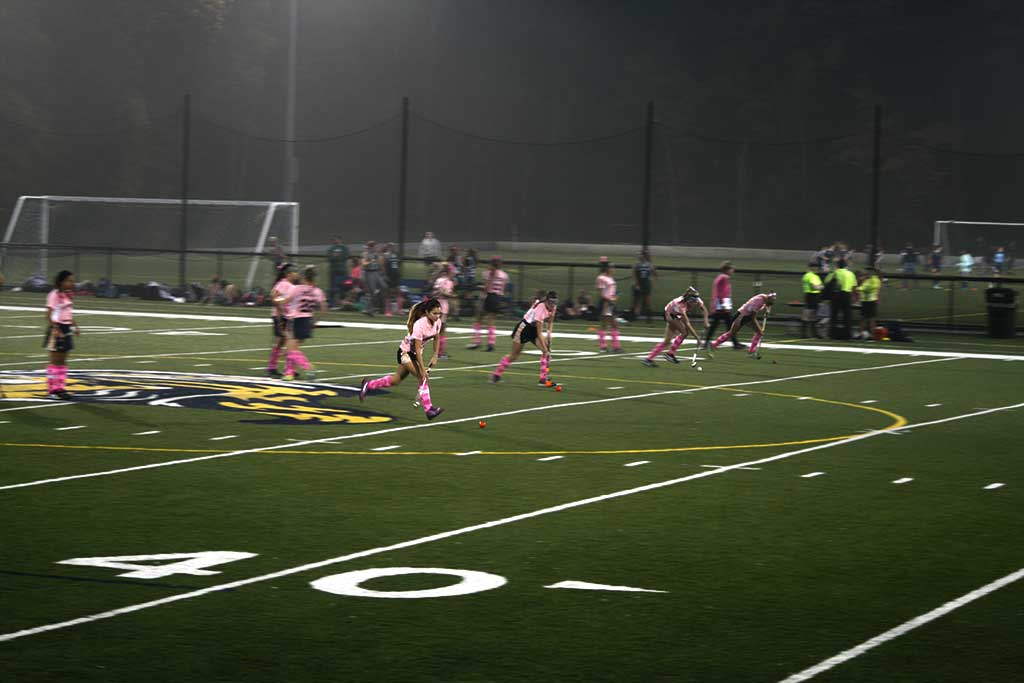 DECKED OUT in pink accessories, the varsity field hockey team stood out even as a dense fog enveloped the team during the Play4TheCure game against Pentucket. The 2-1 win gave coach Mamie Reardon her 300th career victory. (Maria Terris Photo)