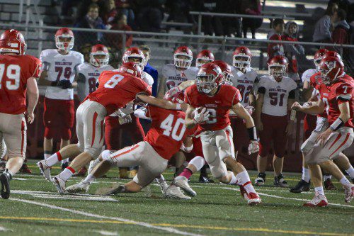 SENIOR Carmen Sorrentino (#2) runs with the ball as teammates Joe Marinaccio (#8) and PJ Iannuzzi (#40) throw blocks for him. Also in the photo are Joe Connell (#79) and Alex McKenna (#7). The Warriors will be seeking a top effort when they take on Danvers in a Div. 2A North quarterfinal game tomorrow night. (Donna Larsson Photo)