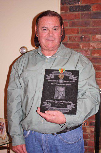 U.S. NAVY VETERAN Tom Tully proudly displays an award and pin he received from The Association of the First Corps of Cadet. Tully was recognized by the organization after serving two tours during the Vietnam War. (Dan Tomasello Photo)