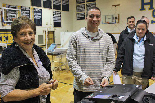 FIRST TIME VOTER Mike Karavetsos was smiling from ear-to-ear after casting his ballot in the Presidential Election on Tuesday. Election worker Estelle Comak (at left) was thrilled to watch Karavetsos cast his first vote. (Dan Tomasello Photo)