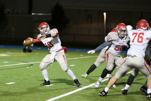 SOPHOMORE QB Mike Lucey (#10) gets ready to release the ball as PJ Iannuzzi (#52) and Brian McGunigle (#76) block for him. Lucey passed for 83 yards and a touchdown as Wakefield shut out Bedford, 13-0. (Donna Larsson File Photo)