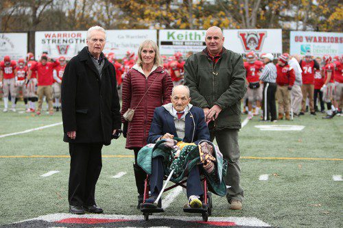RETIRED WMHS Assistant Principal Dennis O'Leary (left) and retired WMHS cross country and track coach John DiComandrea (front) were Honorary Grand Marshals for the ceremonial coin flip at 57th annual Thanksgiving Day Classic last Thursday at Landrigan Field. In the center of the back is Gina Jones and on the right of the back row is former Warrior runner Kevin Crowley. (Donna Larsson Photo)