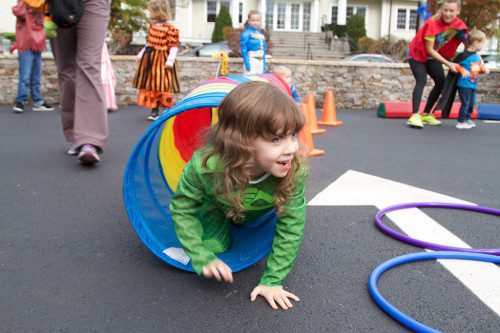 FOUR-YEAR-OLD Lily Holms tackles the obstacle course set up at the Greenwood Plaza during Sunday’s merchants candy giveaway. (Donna Larsson Photo)