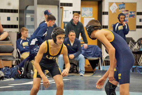FRESHMAN Chris Metrano (at left) won his first varsity match after pinning his 113 lb. Greater Lowell Tech opponent in 42 seconds during the Black and Gold’s 41-34 victory over Greater Lowell Tech Dec. 21. (Courtesy Photo)